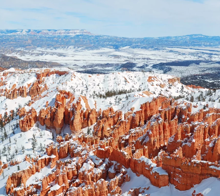 Bryce canyon panorama with snow in Winter with red rocks and blue sky.